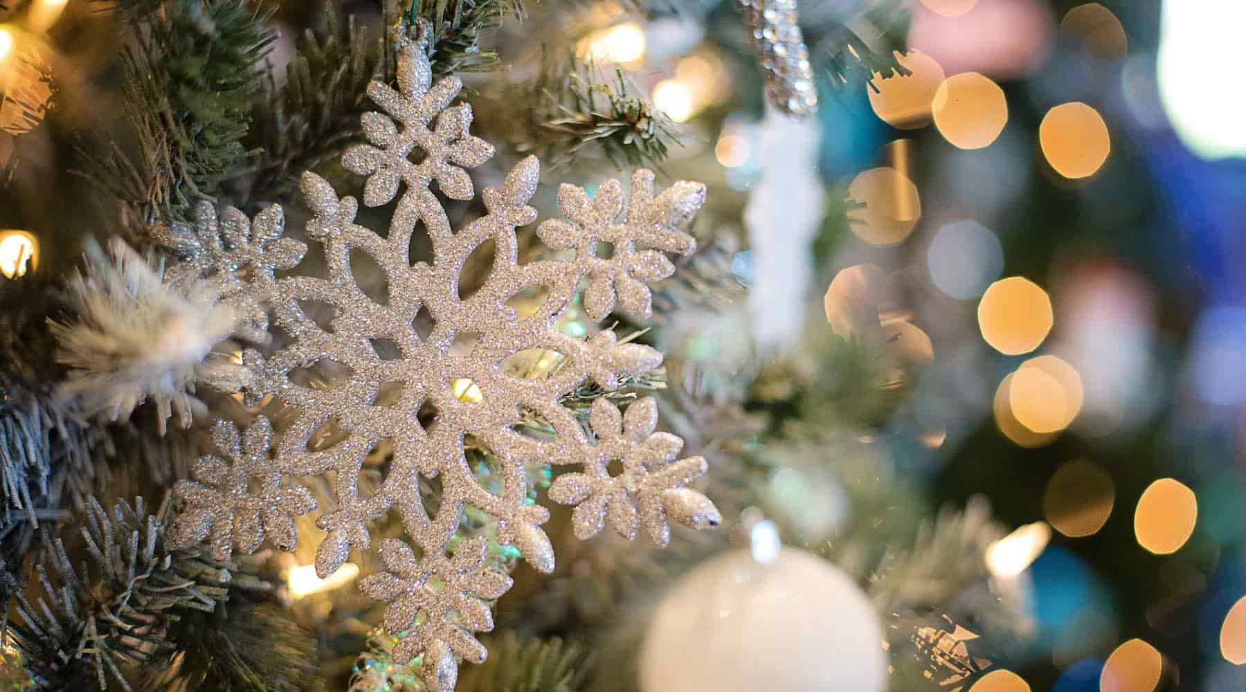 Silver snowflake Christmas ornament on a tree