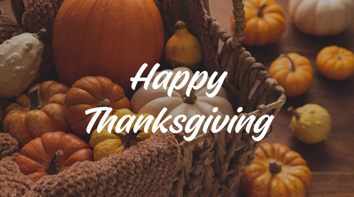 Banner saying "Happy Thanksgiving" with a basket of pumpkins