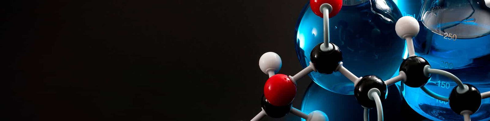 Homeschool chemistry curriculum banner of ball-and-stick models with beakers and flasks containing blue liquid