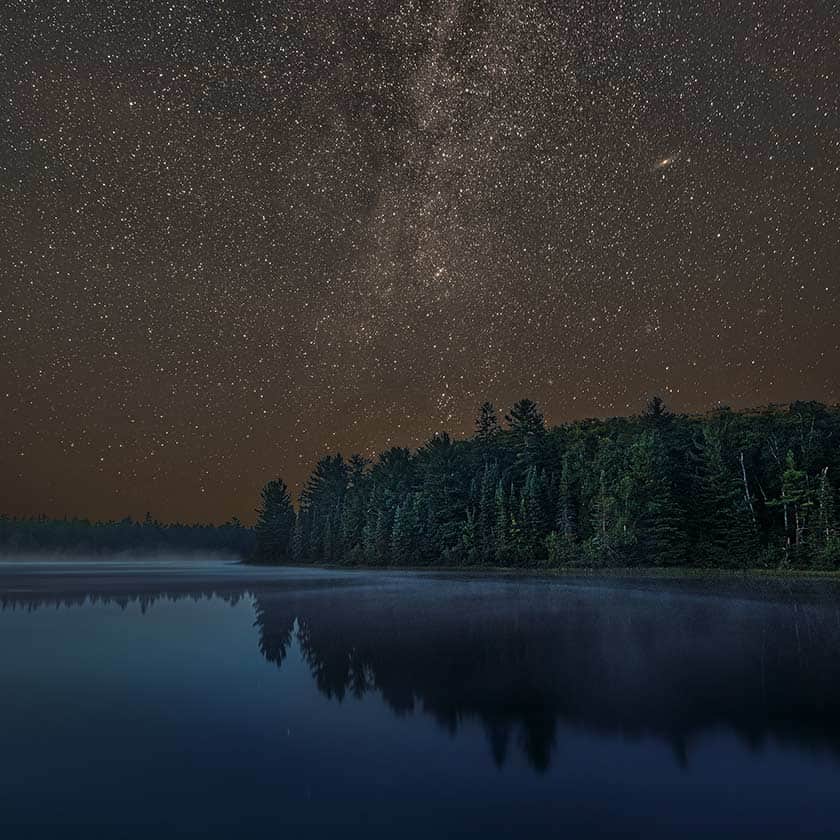 Science Shepherd homeschool astronomy curriculum night sky with Andromeda galaxy over a lake and pine forest