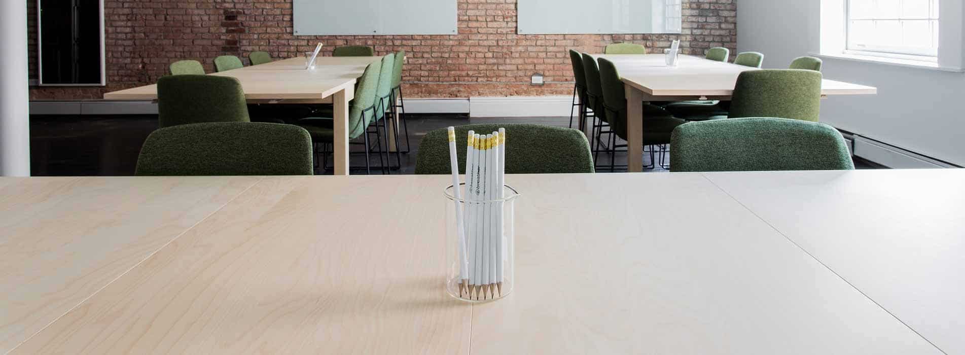 Science Shepherd homeschool co-op classroom with open chairs and jar of pencils